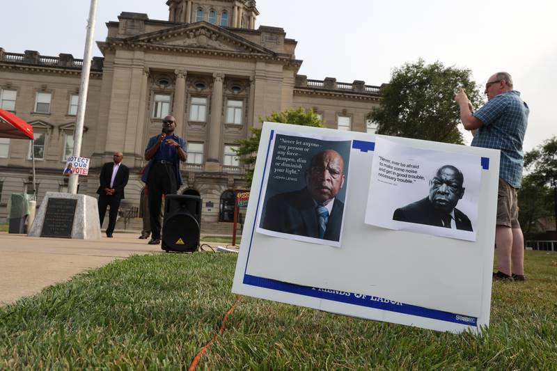 A sign displays quotes the late civil rights leader and congressman John Lewis during a "Good Trouble Lives On" rally held in Kankakee as part of a national day of peaceful protests on Thursday, July 17, 2025.