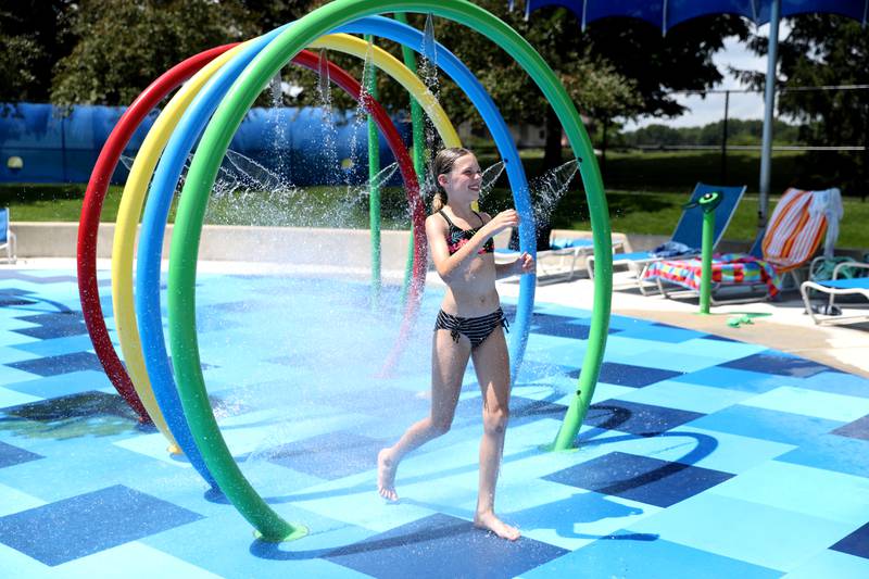 Palmer Danly, 10, runs through a sprinkler at the Otter Cove Aquatic Park’s Splash Park on Tuesday, June 24, 2025 in St. Charles.