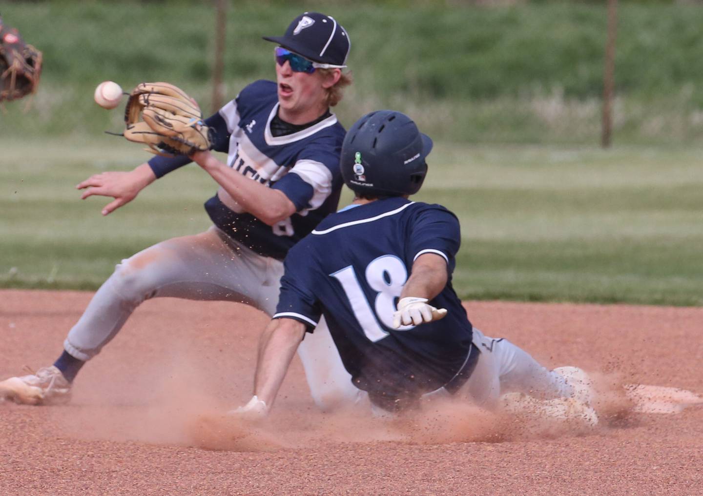 Fieldcrest's Jordan Heider catches a ball at second base as Prairie Central's Clayton Bahler steals a base in a game last season at Fieldcrest Middle School in Wenona.