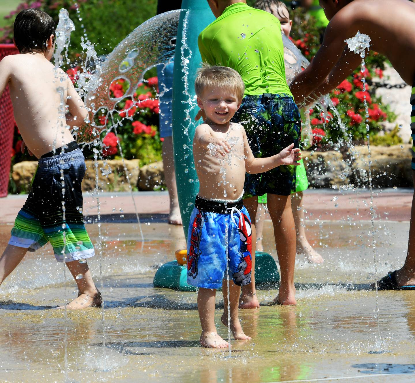 Donovan Barvoner, 3, of Rock Falls, plays with one of the water features while visiting the Dixon Park District's Water Wonderlnd Splash Pad on Tuesday afternoon. As temperatures rose into the 90s, the pad was a popular place for kids and adults to beat the heat.