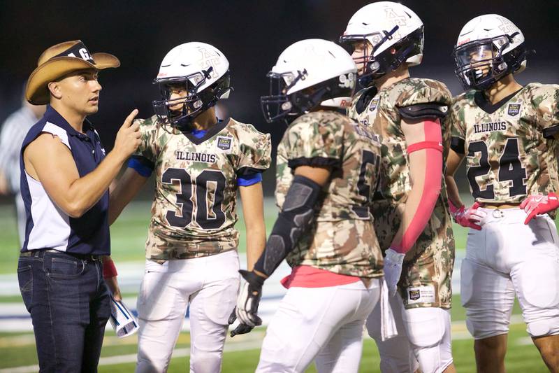 Addison Trails talks strategy against Downers Grove South on Friday, Oct.25,2024 in Addison.