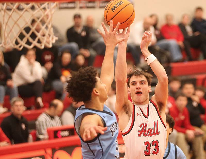 Hall's Braden Curran lets go of a jump shot over Bureau Valley's Dakarai Martin on Wednesday, Jan. 28, 2026 at Hall High School.