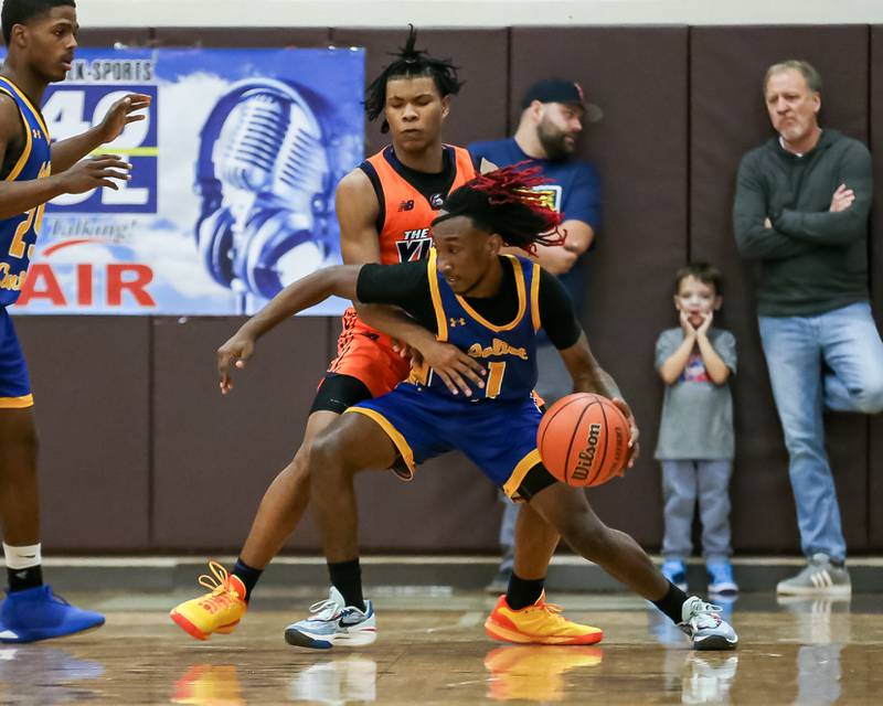 Joliet Central's JaMarcho Holman (1) is defended by Romeoville's Ej Mosley Jr (5) in the WJOL Tournament Championship game. Nov 25, 2023.