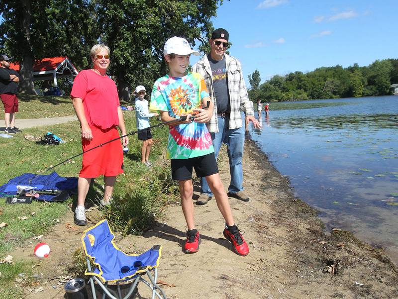 Austin Krueger, 10, stands next to his uncle, Greg, and father, Roger, all of Round Lake Park while he fishes on the shore of Round Lake during the Family Fishing Event at Lake Front Park on Saturday, September 9th in Round Lake Beach. The event was sponsored by the Round Lake Area Park District and the Huebner Fishery Management Foundation.
Photo by Candace H. Johnson for Shaw Local News Network