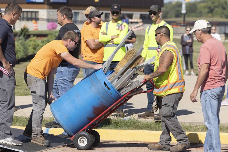 City workers remove equipment used to construct the wall Thursday, August 31, 2023 in Rock Falls. The wall took a few hours to put up after it arrived.