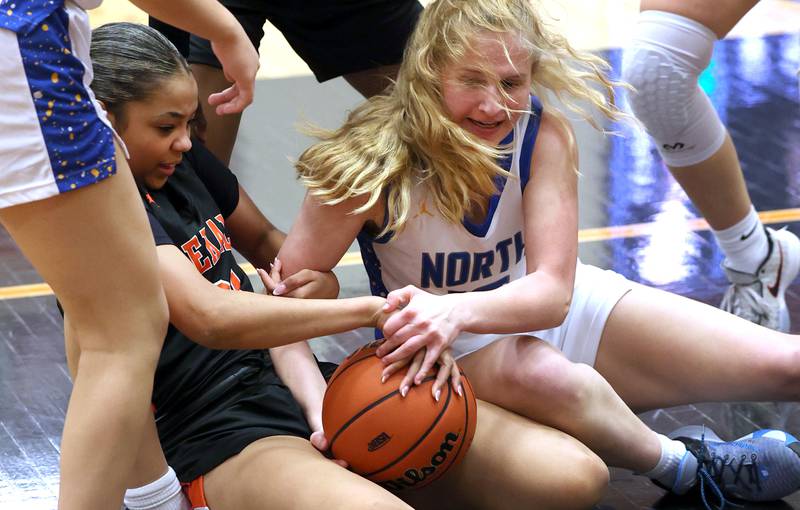DeKalb’s Alicia Johnson and Wheaton North's Anna Leicht go after a loose ball during their Class 4A regional game Monday, Feb 12, 2024, at DeKalb High School.