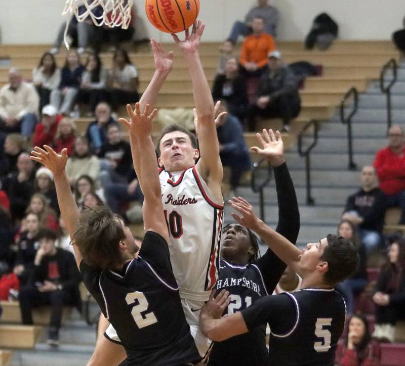 Huntley’s Brady Hassels works under the hoop against Hampshire in varsity boys basketball on Friday, Dec. 19, 2025, at Huntley High School in Huntley.