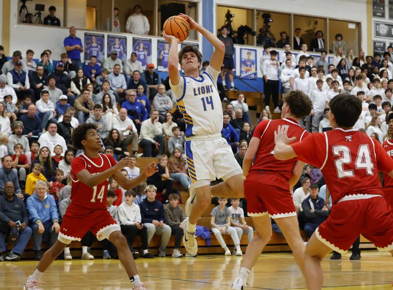 Lyons Township's Grant Smith (14) puts up a shot during a varsity basketball game between Hinsdale Central and Lyons Township high schools on Friday, Dec. 12, 2025 in La Grange.