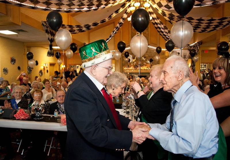 Bob McGarry, left, is crowned 2016 Prom King by last year’s King Vince Burnetti during The Timbers of Shorewood's annual Seniors’ Senior Prom titled, “Top Hats & Bow Ties” June 24 in Shorewood.