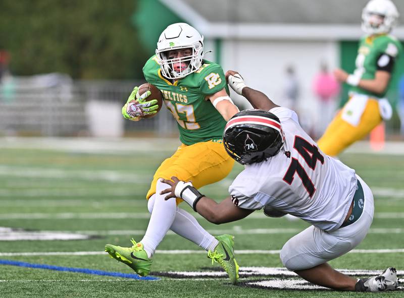 Providence's Jackson Killeen (27) stiff-arms Springfield's Trey Sutton (74) during the Class 5A first-round playoff game Saturday, Nov. 01, 2025, in New Lenox.