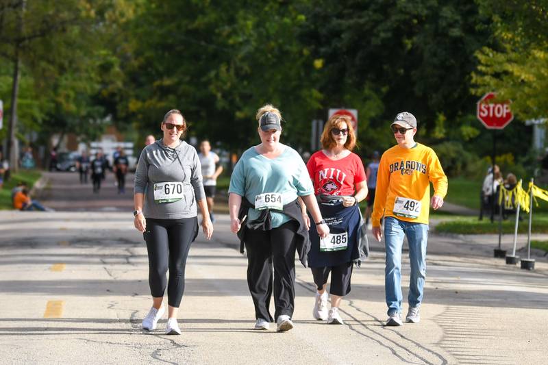 (From left) Tiffany Mills, Jen Bock, Peggy Kelly and Dan Dutile finish off the DeKalb Corn Classic 5K/10K race on Sunday, Sept. 29, 2024, downtown.