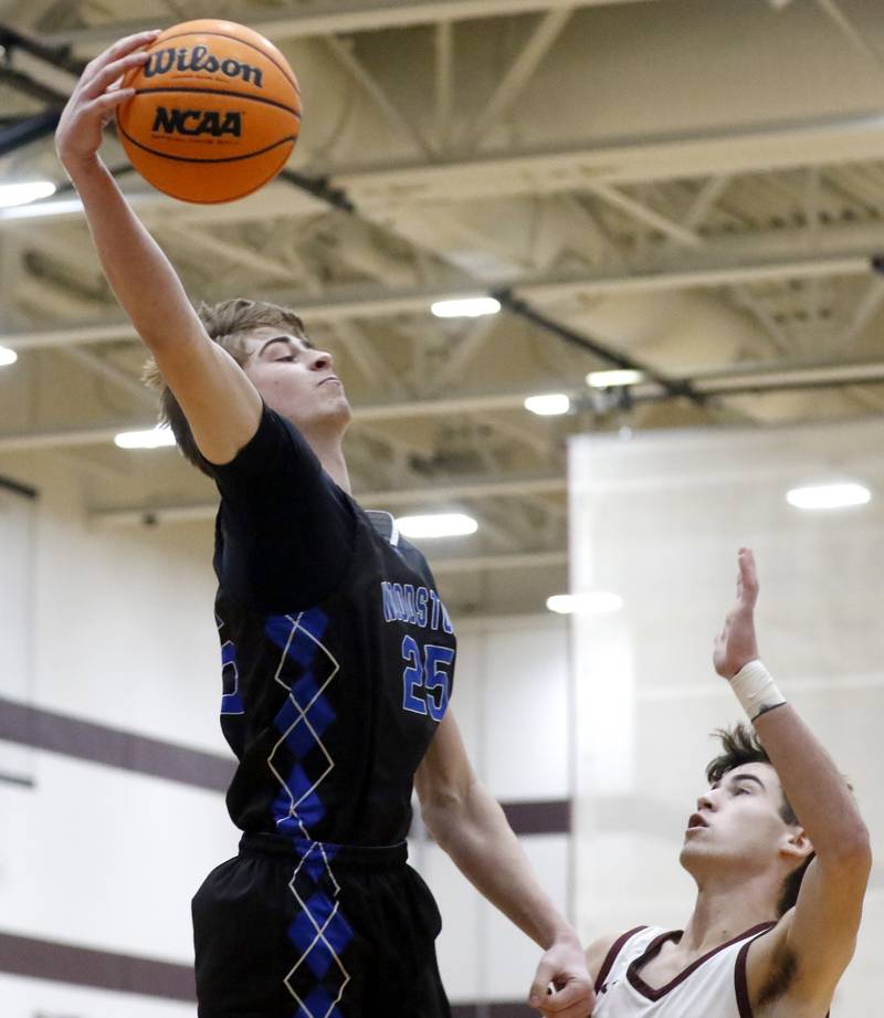 Woodstock's Liam Laidig tries to save the basketball from going our of bounds in front of Richmond-Burton's Dane Gardner during a Kishwaukee River Conference boys basketball game on Friay Jan. 9  2026, at Richmond-Burton High School, in Richmond.