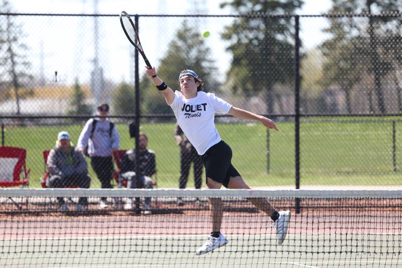 Joliet Township’s Paul Coffey leaps for the return shot against Joliet Catholic’s Andy Munoz on Saturday, April 6, 2024 in Joliet.
