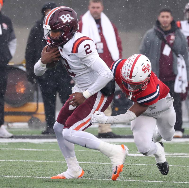 Brother Rice's CJ Gray gets by St. Rita's Langston Smith Wednesday, Dec. 3, 2025, during their IHSA Class 7A state chamionship game in Huskie Stadium at Northern Illinois University in DeKalb.