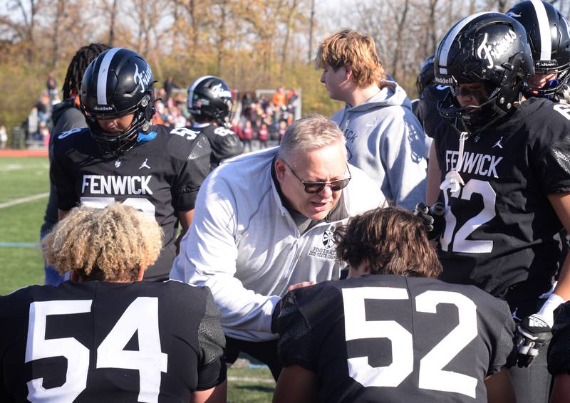 Fenwick's offensive line coach Craig Schneider talks with his team during their playoff game against Brother Rice Saturday, Nov. 2, 2024.