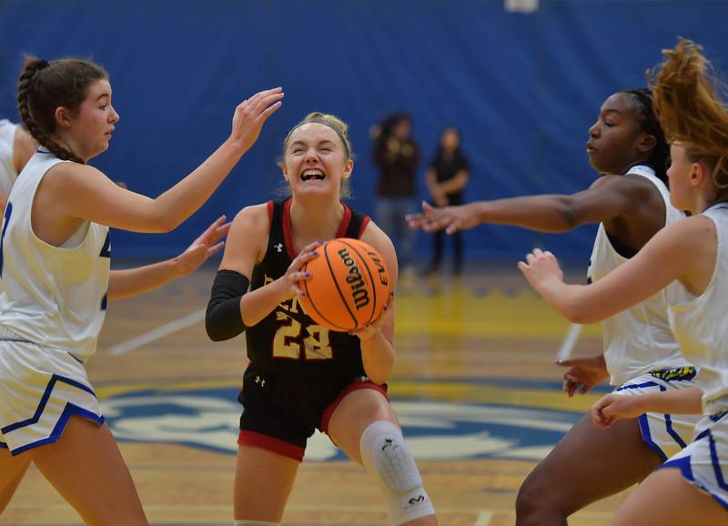 Benet's Bridget Rifenburg (22) tries to get to the basket through a gauntlet of Lyons Township defenders during a game on November 19, 2024 at Lyons Township High School in LaGrange.