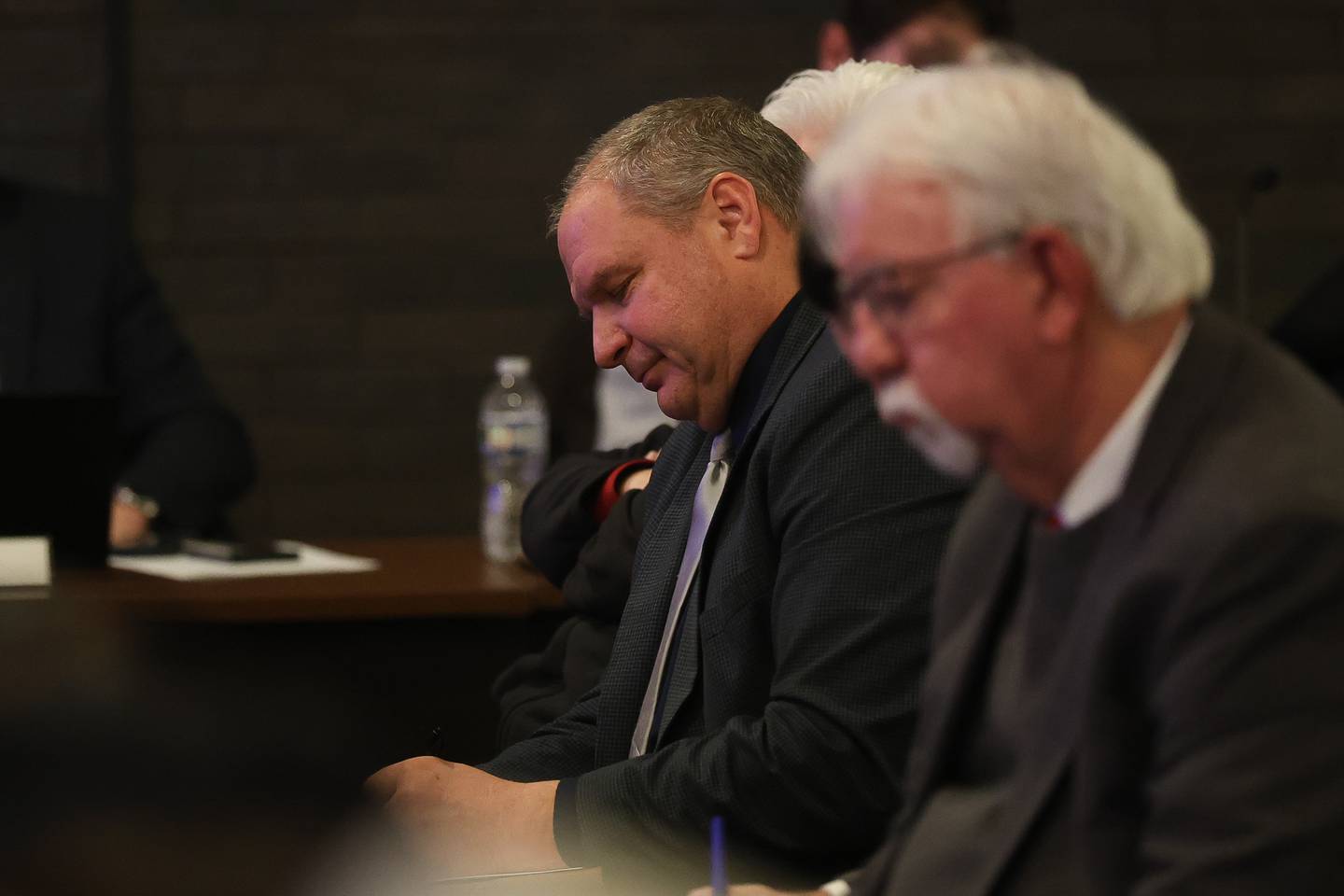 Joliet Catholic Academy President and Principal Jeff Budz takes notes during the Joliet city council meeting to vote on the Joliet Catholic Academy stadium plan on Tuesday, Jan 20, 2026 in Joliet.