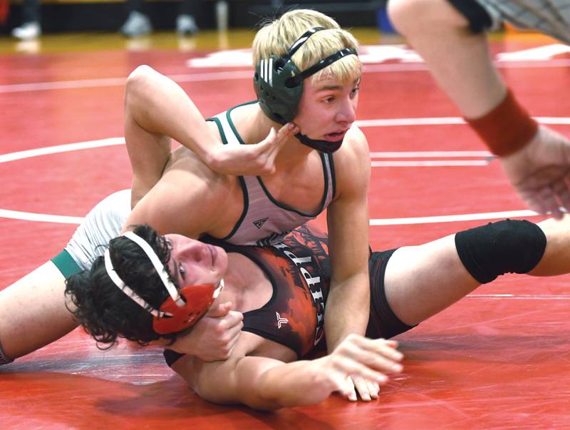 West Carroll's Jonner Smith (top) wrestles Amboy's Kai Force in their 175 pound match at Oregon High School on Tuesday, Nov. 25, 2025.
