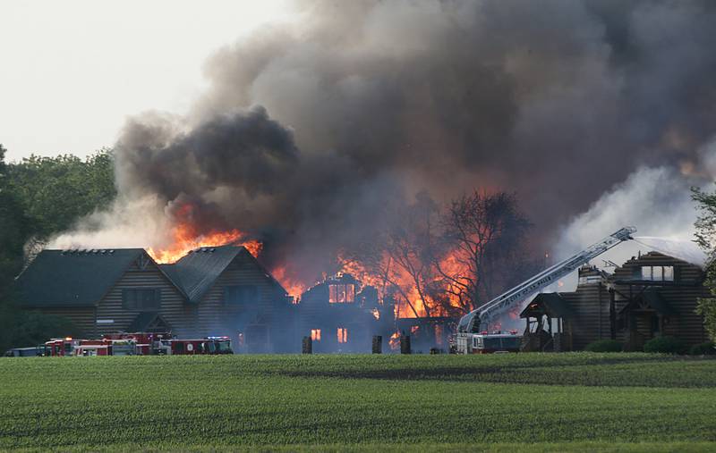 Large flames engulf several cabins at Grand Bear Resort on Monday, May 30, 2022. High winds made it extremely difficult for firefighters to battle the flames.