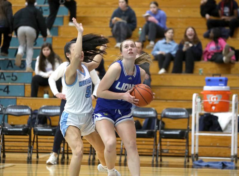 Lyons Township's Gwen Smith looks for an opening during the West Suburban Conference championship game against Downers Grove South on Thursday, Feb. 13, 2025 at Willowbrook High School.