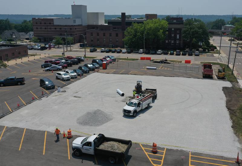Crews from CAMCO Construction work on paving a lot at the corner of 7th and West Street on Monday, July 7, 2025 at OSF St. Elizabeth West Hospital in Peru.