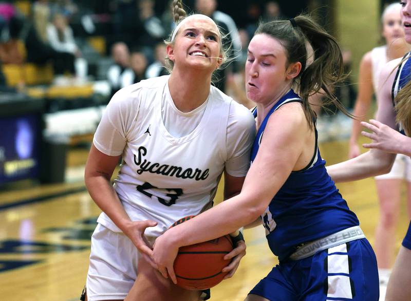 Sycamore's Evyn Carrier is tied up by Geneva's Cassidy Arni during their game Monday, Nov. 14, 2022, at Sycamore High School.
