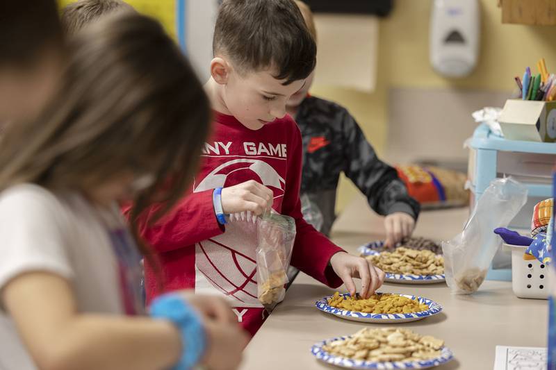 First grader Lucas Lance counts out 10 goldfish Thursday, Jan. 26, 2023 in class at Washington School in Dixon.