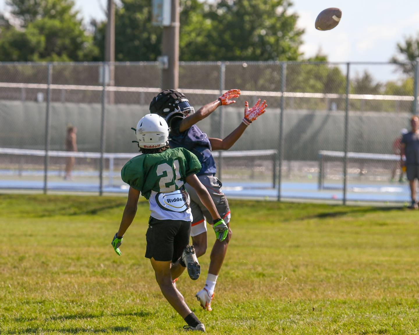 Jeremiah Cain, right, catches a pass while being defended by Waubonsie Valley on Thursday July 18, 2024, during a combined practice held at Waubonsie Valley High School in Aurora.