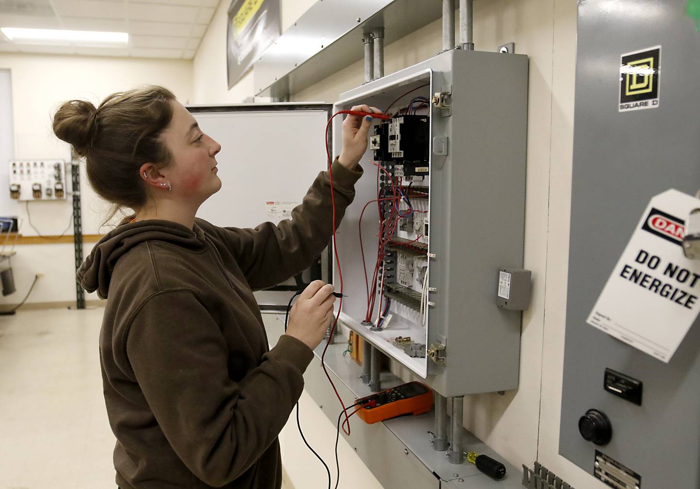 Megan True checks out an electrical box on Monday, Dec. 9, 2024, in a training room at International Brotherhood of Electrical Workers Local 117 in Crystal Lake.