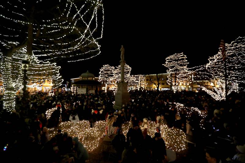 Lights surround people during the Lighting of the Square on Friday, Nov. 28, 2025, in Woodstock.The annual holiday season event featured brass music, caroling, free doughnuts and cider, food trucks, festive selfie stations and shopping.