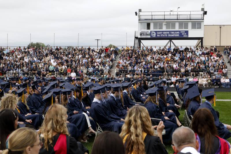 Graduates listen to Cary-Grove Principal Neil Lesinski speak during the graduation ceremony for the class of 2023 at Cary-Grove High School in Cary.