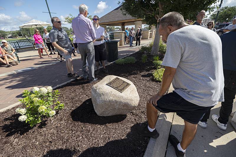 Fred Rogers checks out the plaque dedicated to John Groshans during a ceremony in Dixon on Friday, Aug. 9, 2024.