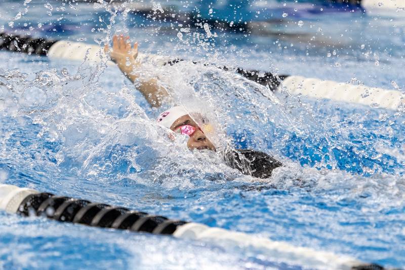 Plainfield’s Mia Ceballos competes in the 100 Yard Backstroke during the IHSA Girls State Swimming Preliminaries at FMC Natatorium in Westmont on Nov. 14, 2025.