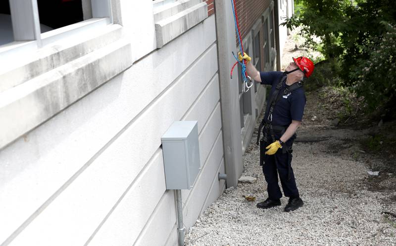 Geneva Fire Chief Michael Antenore completes a rappelling training exercise at the Third Street Commuter Parking Deck on Tuesday, May 13, 2025 in Geneva.