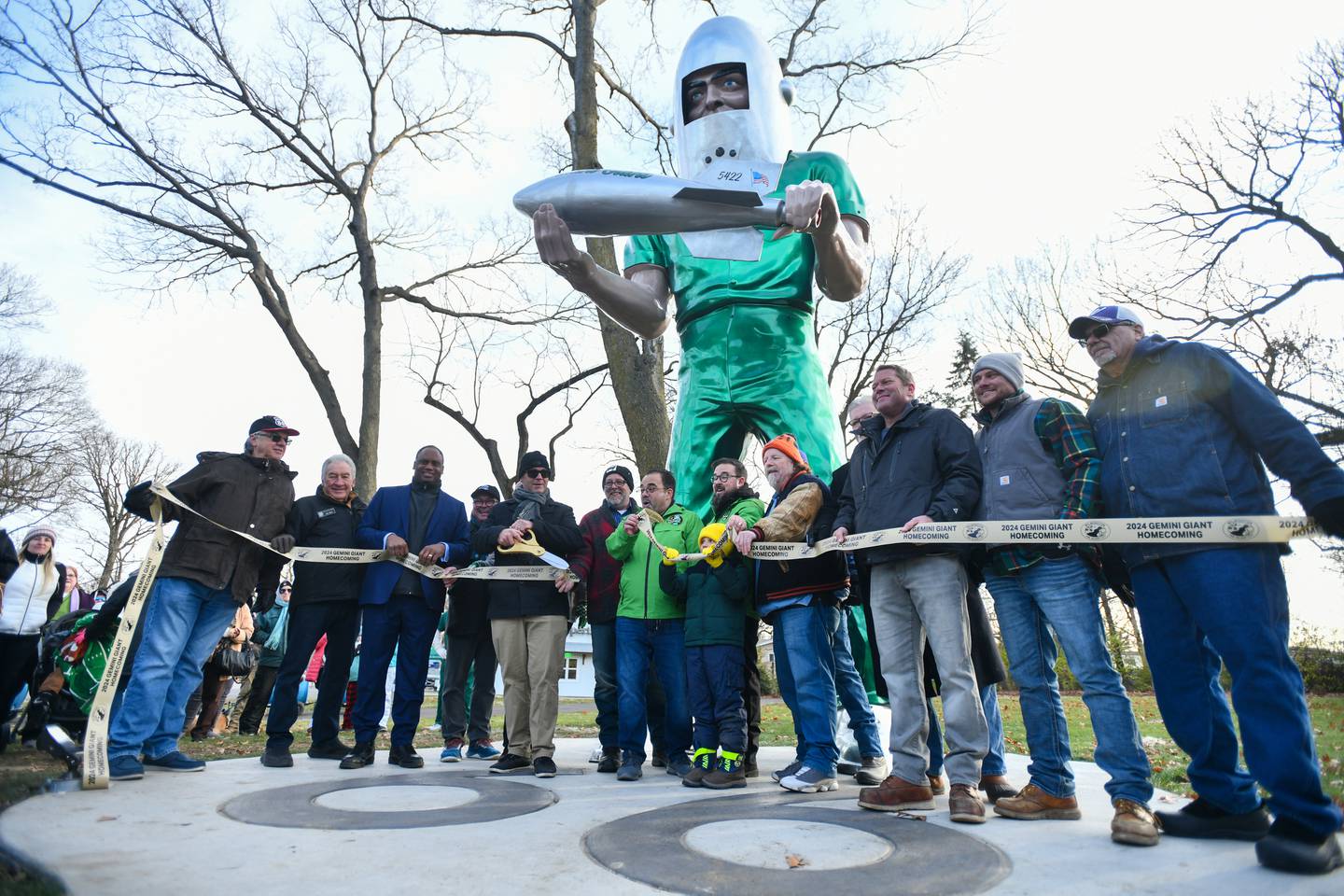 Wilmington Mayor Ben Dietz, left of center, cuts the ceremonial ribbon alongside representatives from the Joliet Area Historical Museum and other local and state officials at the base of the Gemini Giant on Saturday during the Gemini Giant Homecoming event at Wilmington's South Island Park.