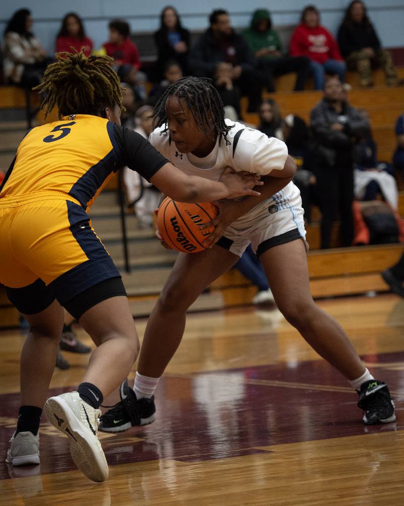 Kankakee's Lamaryah Smith controls the ball as Thornwood's Ashlee Veley, left, defends in a game on Thursday, December 11, 2025.