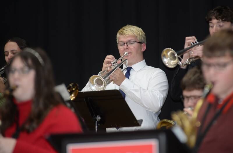 Isaac Ebert plays the trumpet for the Oregon High School Jazz Band as they play a selection of tunes Saturday, Nov. 30, 2024, inside the Coliseum Museum of Art, Antiques & Americana during Oregon's Candlelight Walk.