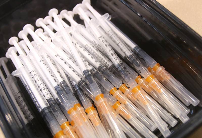 Syringes filled with the COVID-19 vaccine wait to be administered during a clinic at the Convocation Center at Northern Illinois University in DeKalb.
