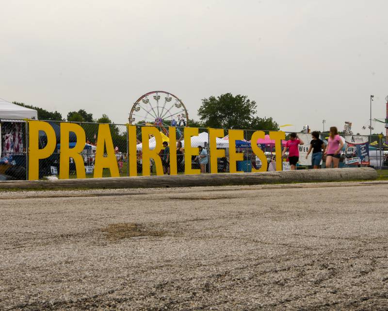 Community members make their way to the entrance of PrairieFest on Thursday June 12, 2025, held at Prairie Fest Park in Oswego.
