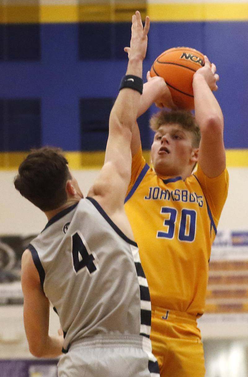 Johnsburg's Jayce Schmitt shoots the ball over Cary-Grove's Dylan Dumele during a Johnsburg Thanksgiving Tournament boys basketball game on Monday, Nov. 24, 2025, at Johnsburg High School.
