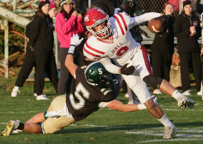 Hall's Braden Curran (8) spins around St. Bede's Callan Hueneburg (5) to gain extra yards on Saturday, Oct. 15, 2022 at the Academy in Peru.