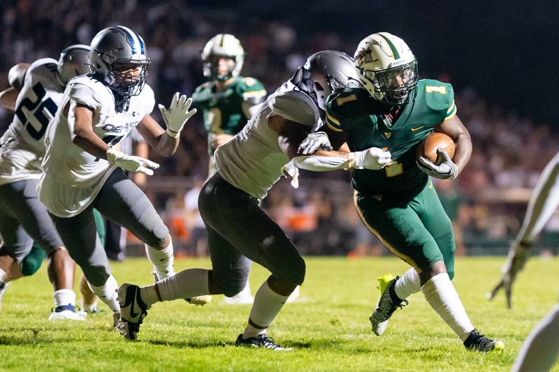 Waubonsie Valley's Chrisjan Simmons (1) carries the ball against Oswego East during a football game at Waubonsie Valley High School in Aurora on Friday, Aug. 25, 2023.