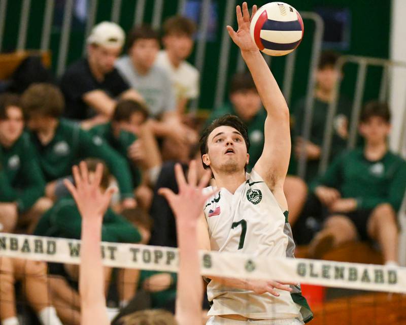 Glenbard West's Adam Graham (7) spikes the ball past Oak Park-River Forest defenders on Tuesday April 16, 2024, held at Glenbard West High School.