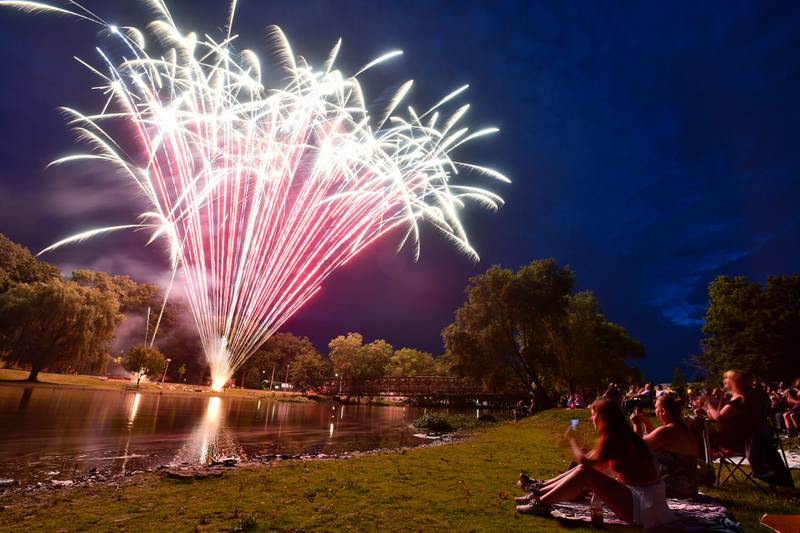 Spectators watch from the riverbank near Momence’s Island Park during the fireworks show on July 4.