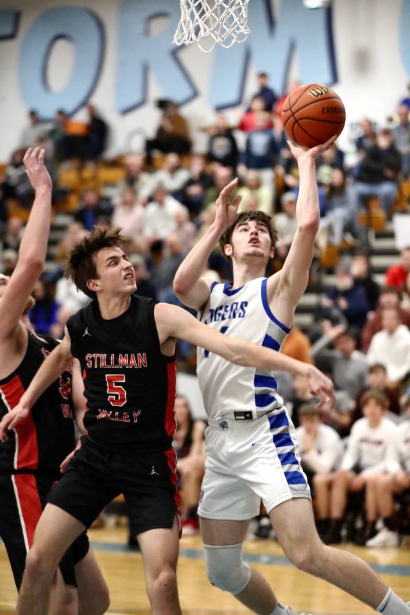 Princeton's Grady Thomson shoots over Stillman Valley's Drake Stewart Friday night at the Storm Cellar. The Tigers won 68-37, to repeat as regional champions.