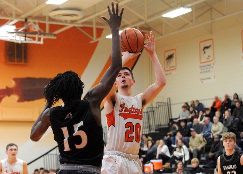 Sandwich's Owen Sheley (20) takes a jump shot over Kaneland defender Freddy Hassan (15) during a boys' basketball game at Sandwich High School on Friday, Jan. 13, 2023.
