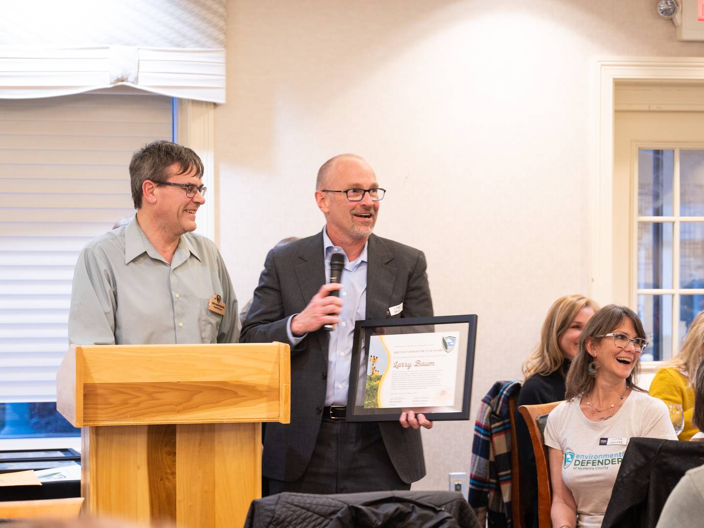 Environmental Defenders of McHenry County board member Ken Santowski, left, presents Larry Baum with Volunteer of the Year Award on Sunday March 13, 2022, at the McHenry Country Club.