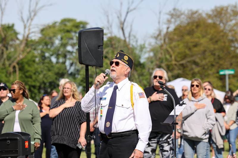 Tim Rehmer sings the National Anthem along with over 100 attendees during a ceremony dedicated to the late John Kirnbauer, a veteran whose ashes went unclaimed for five years, on Monday, May 26, 2025, at Kankakee Memorial Gardens.