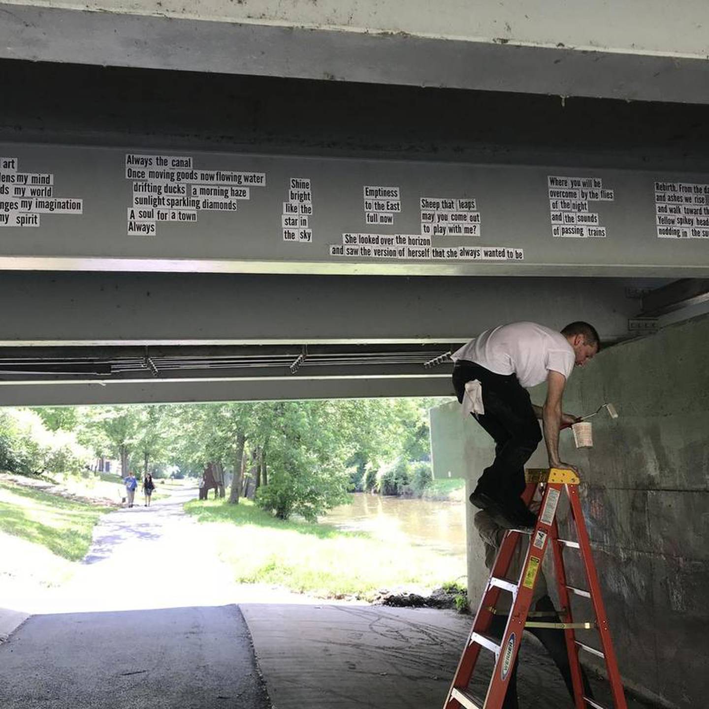 Love has displayed the results of all these projects beneath the underpass between the Gaylord and Norton buildings – using wheat paste so the words will stand up to both the elements and the passing of time, Love said.

"I pay special attention to the edges so they don't peel off," Love said.
He chose that area because it's a community space that was attracting a lot of inappropriate graffiti, Love said. And he's all about "community words and reclaiming spaces."

"I'm not against graffiti," Love said. "But what people are submitting on the cares and at the workshops is beautiful. People really understand this community and their love for it. Visitors will see the beauty of it, too."

Love said he did a similar project in Gary last year, collecting over 1,000 lines of poetry. With a master's degree in history and Love himself being a poet. Love said he wanted to present Gary as something more than "blight, murder and Michael Jackson."