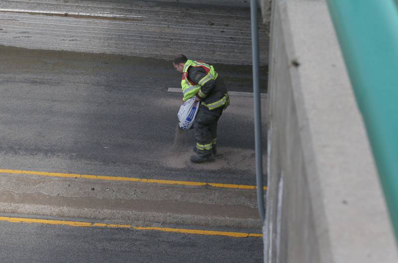 Peru firefighters work the scene of a tractor and tandem disk that leaked hydraulic fluid on the shoulder of Illinois Route 251 and 7th Street overpass on Monday, April 28, 2025. Peru Fire, Illinois Department of Transportation and Peru police responded to the incident.